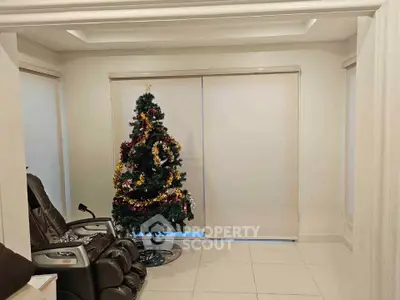 Cozy living room with massage chair and festive Christmas tree, perfect for holiday relaxation.