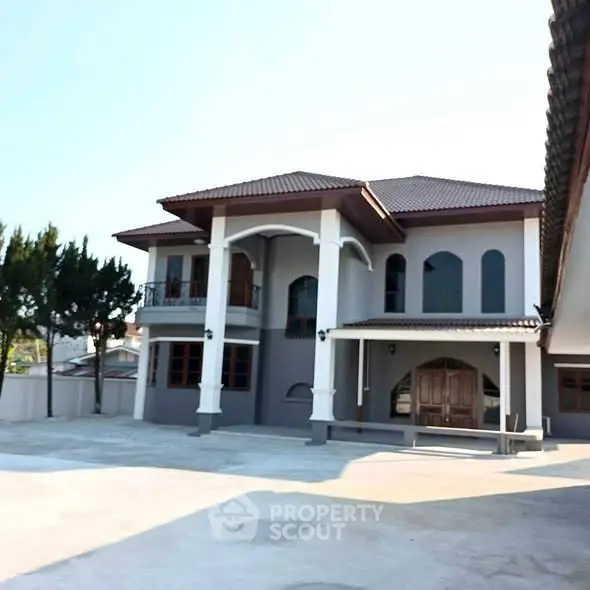 Stunning two-story house with elegant facade and spacious driveway, perfect for luxurious living.