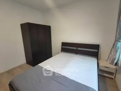Spacious bedroom with modern furnishings and ample natural light