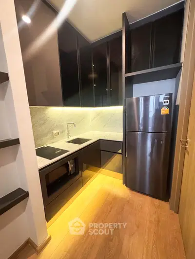 Modern kitchen with sleek cabinets and stainless steel appliances in a compact layout.