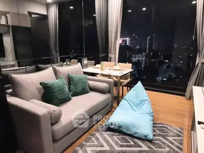 Modern living room with city view, cozy sofa, and stylish decor.