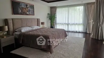 Luxurious bedroom with elegant decor and large window view