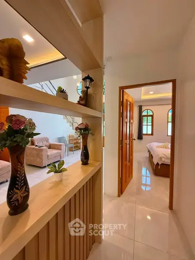 Elegant interior view showcasing a cozy living room and inviting bedroom with stylish decor and natural light.