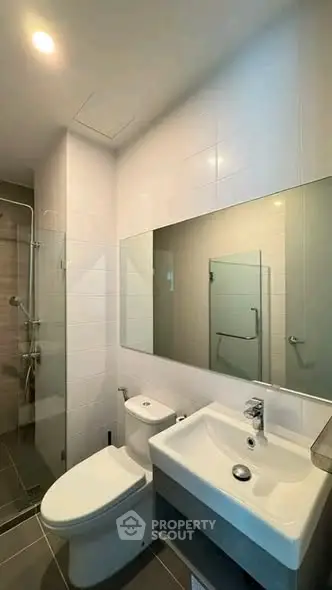 Modern bathroom with sleek fixtures and spacious shower area