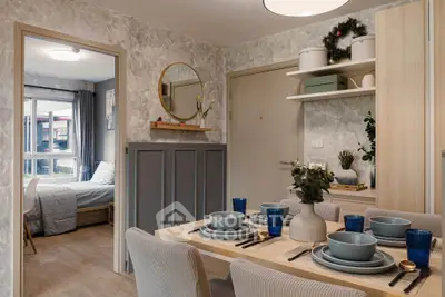 Stylish dining area with modern decor and view into cozy bedroom