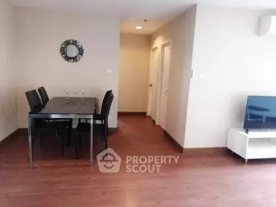 Spacious living room with dining area and modern decor in a stylish apartment.
