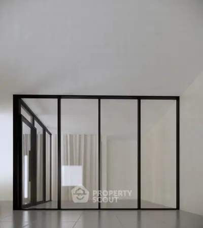Modern minimalist interior with glass partition and sleek design.