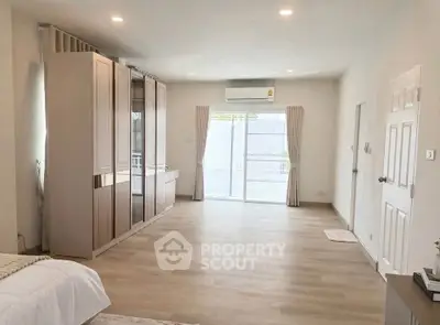 Spacious bedroom with modern design and large windows for natural light
