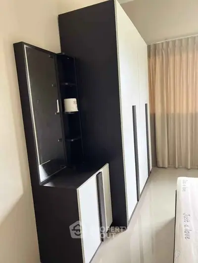 Modern bedroom with sleek wardrobe and elegant curtains