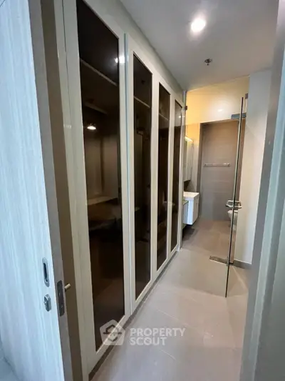 Modern bathroom with sleek glass shower and ample storage space