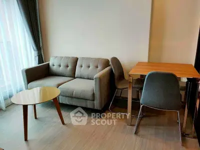 Modern living room with stylish sofa and dining table, perfect for cozy gatherings.