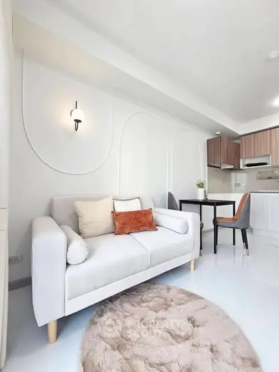 Modern living room with cozy sofa and stylish kitchen in open layout