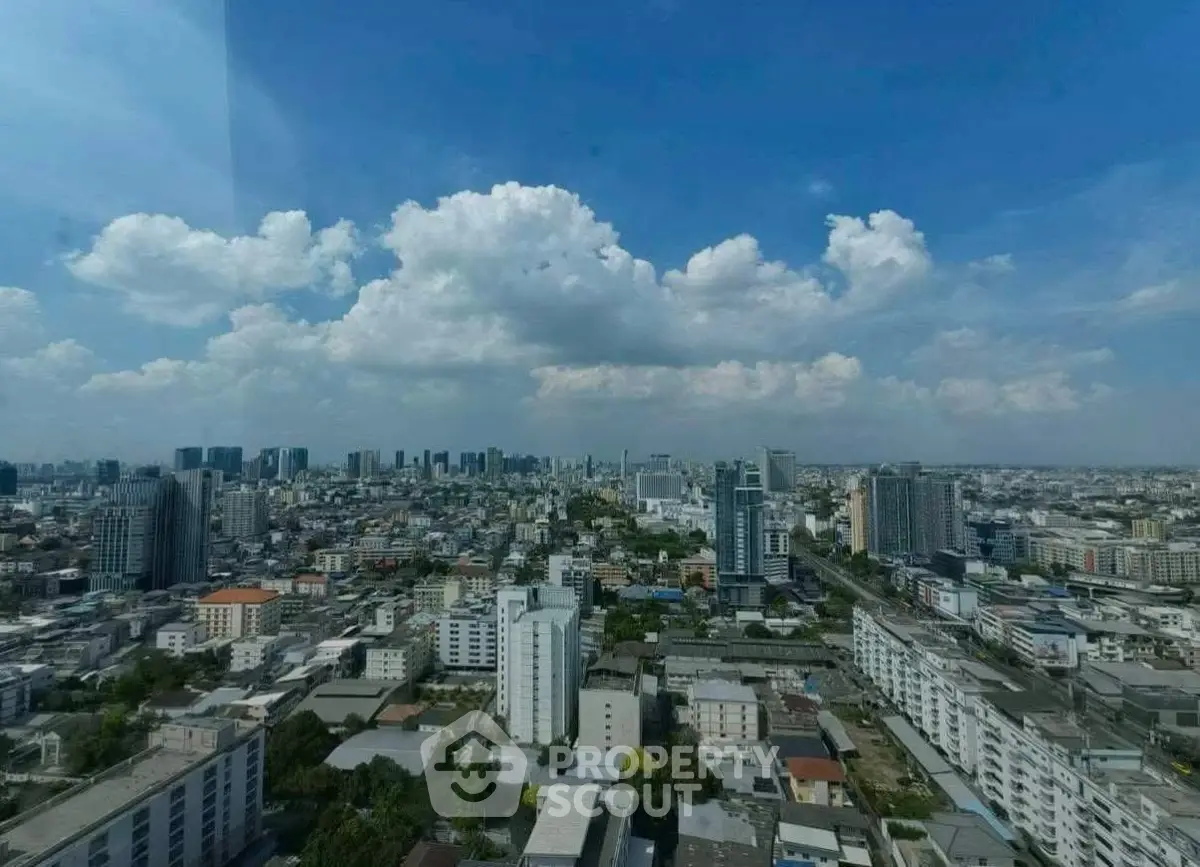 Stunning cityscape view from a high-rise building showcasing urban skyline under a clear blue sky.