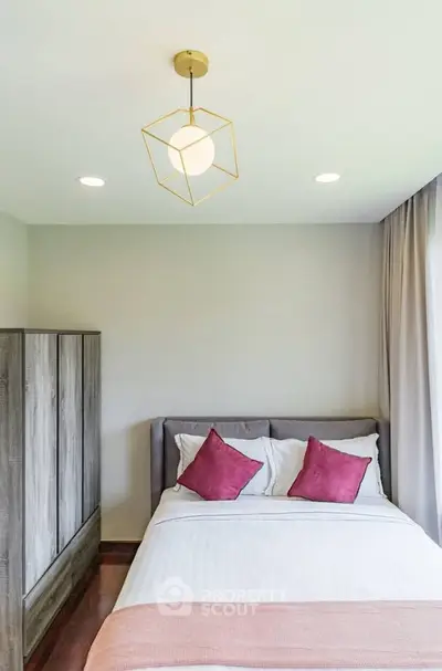 Cozy bedroom with modern lighting and stylish decor, featuring a comfortable bed and elegant wardrobe.