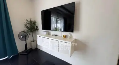 Modern living room with sleek wall-mounted TV and minimalist decor