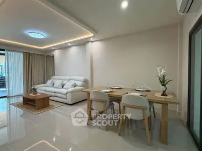 Modern living room with elegant dining area and cozy sofa