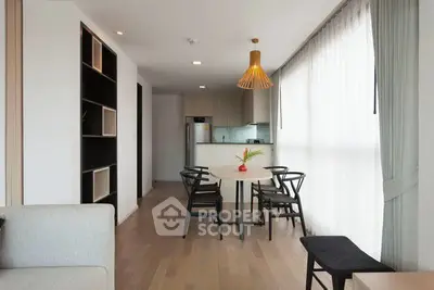 Modern open-layout living room with dining area and stylish lighting