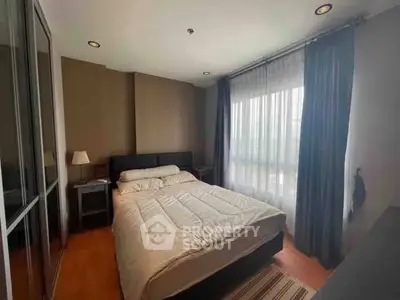 Cozy bedroom with modern decor and large window for natural light