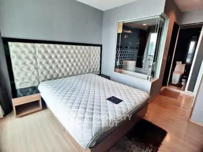 Luxurious bedroom with plush headboard and modern ensuite bathroom