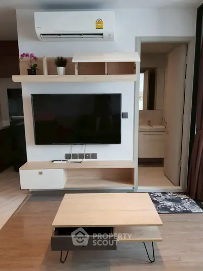 Modern living room with wall-mounted TV and air conditioning unit, featuring sleek wooden furniture.