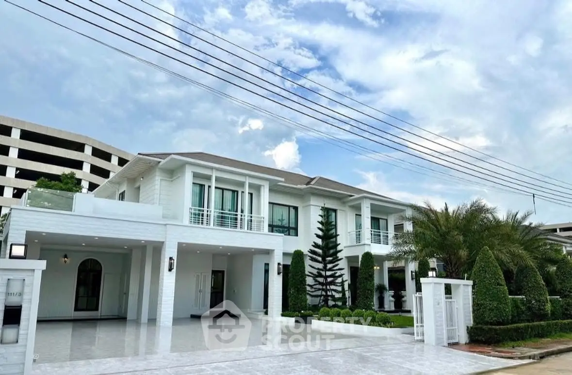Luxurious modern mansion with spacious driveway and lush landscaping