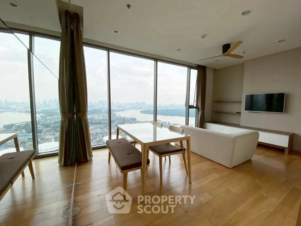 Stunning high-rise living room with panoramic city views and modern furnishings.