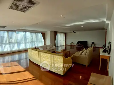 Spacious living room with elegant furniture and large windows offering abundant natural light.