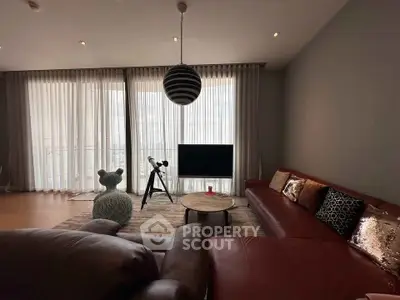 Luxurious living room with modern decor and large windows offering ample natural light.