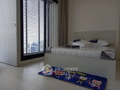 Modern bedroom with large window and stylish decor in urban apartment
