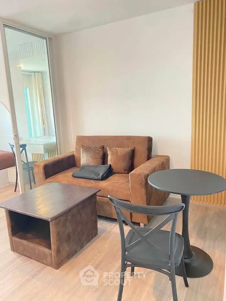 Modern living room with stylish brown sofa and sleek black table, perfect for cozy relaxation.
