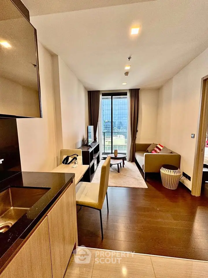 Modern living room with city view, open layout, and stylish furnishings in a high-rise apartment.