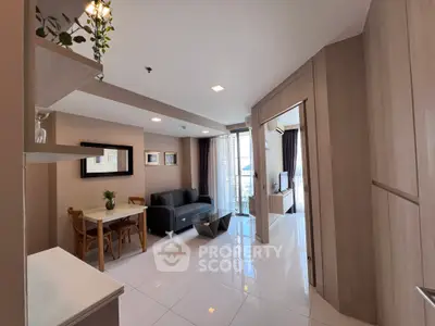 Modern living room with sleek design and open layout, featuring a cozy dining area and stylish decor.
