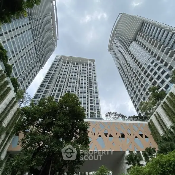 Stunning modern high-rise buildings with lush greenery and unique architectural design.