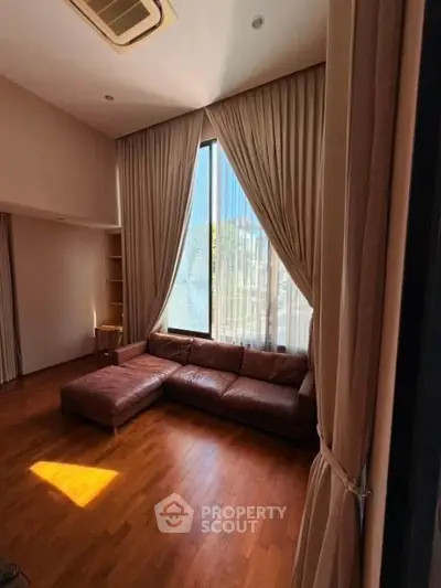 Luxurious living room with high ceilings and elegant curtains