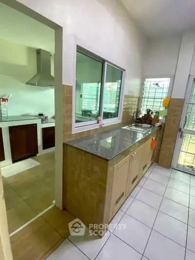 Spacious kitchen with granite countertops and modern appliances in a bright home