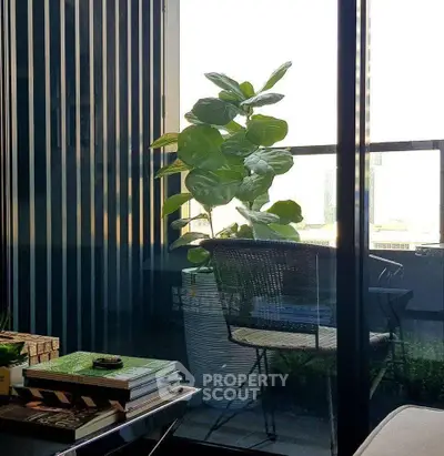 Chic balcony with modern decor and lush plant, perfect for relaxation.