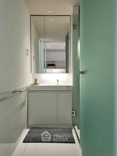 Modern minimalist bathroom with sleek design and large mirror