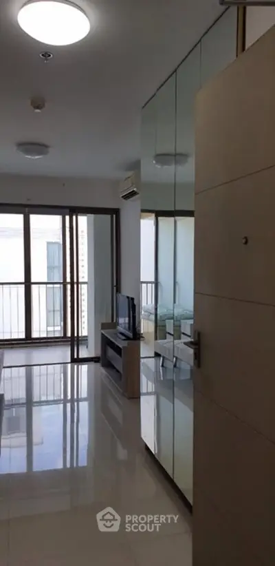 Modern living room with sleek design and large windows offering natural light.