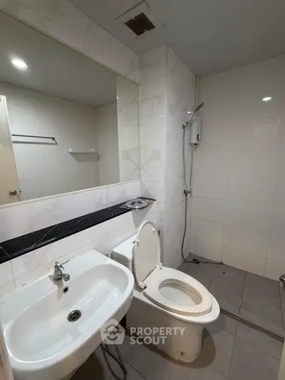 Modern bathroom with sleek fixtures and spacious shower area.