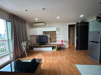 Spacious living room with modern furniture and balcony view in urban apartment.