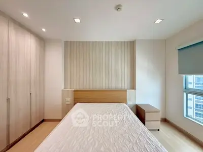 Modern bedroom with wooden accents and large window offering city view