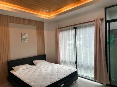 Modern bedroom with stylish ceiling and large window for natural light