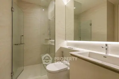 Modern bathroom with glass shower and sleek fixtures