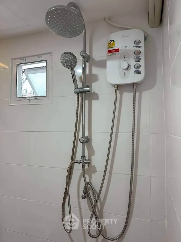 Modern bathroom shower with water heater and dual showerheads.