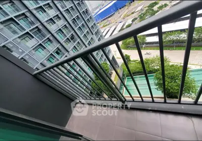Modern high-rise balcony with city view and sleek railing design.