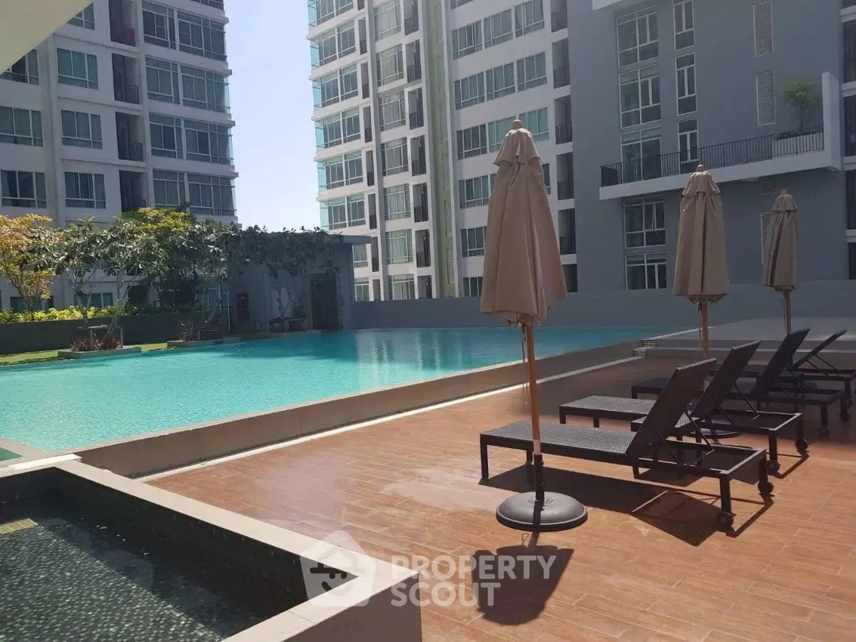 Luxurious apartment complex with stunning poolside view and modern amenities.