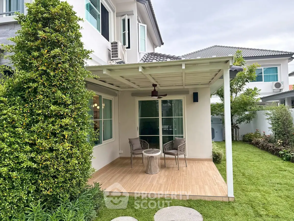 Charming backyard patio with cozy seating and lush garden in modern home