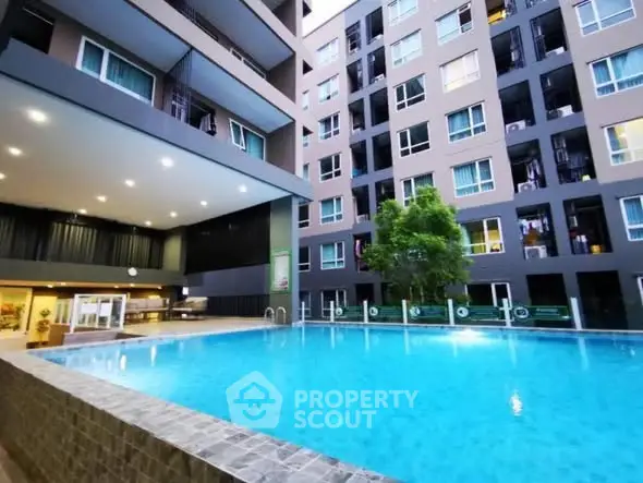 Modern apartment complex with a stunning outdoor pool and sleek architecture.