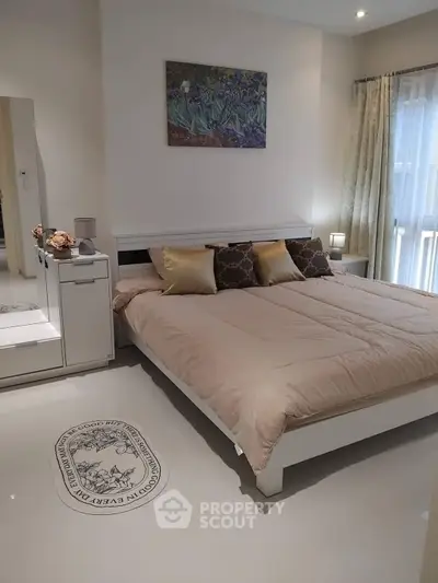 Elegant bedroom with cozy bed, stylish decor, and natural light for a serene living experience.