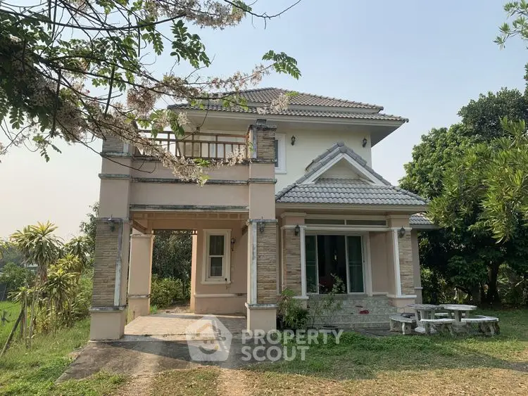 Charming two-story house with lush garden and spacious outdoor area, perfect for family living.